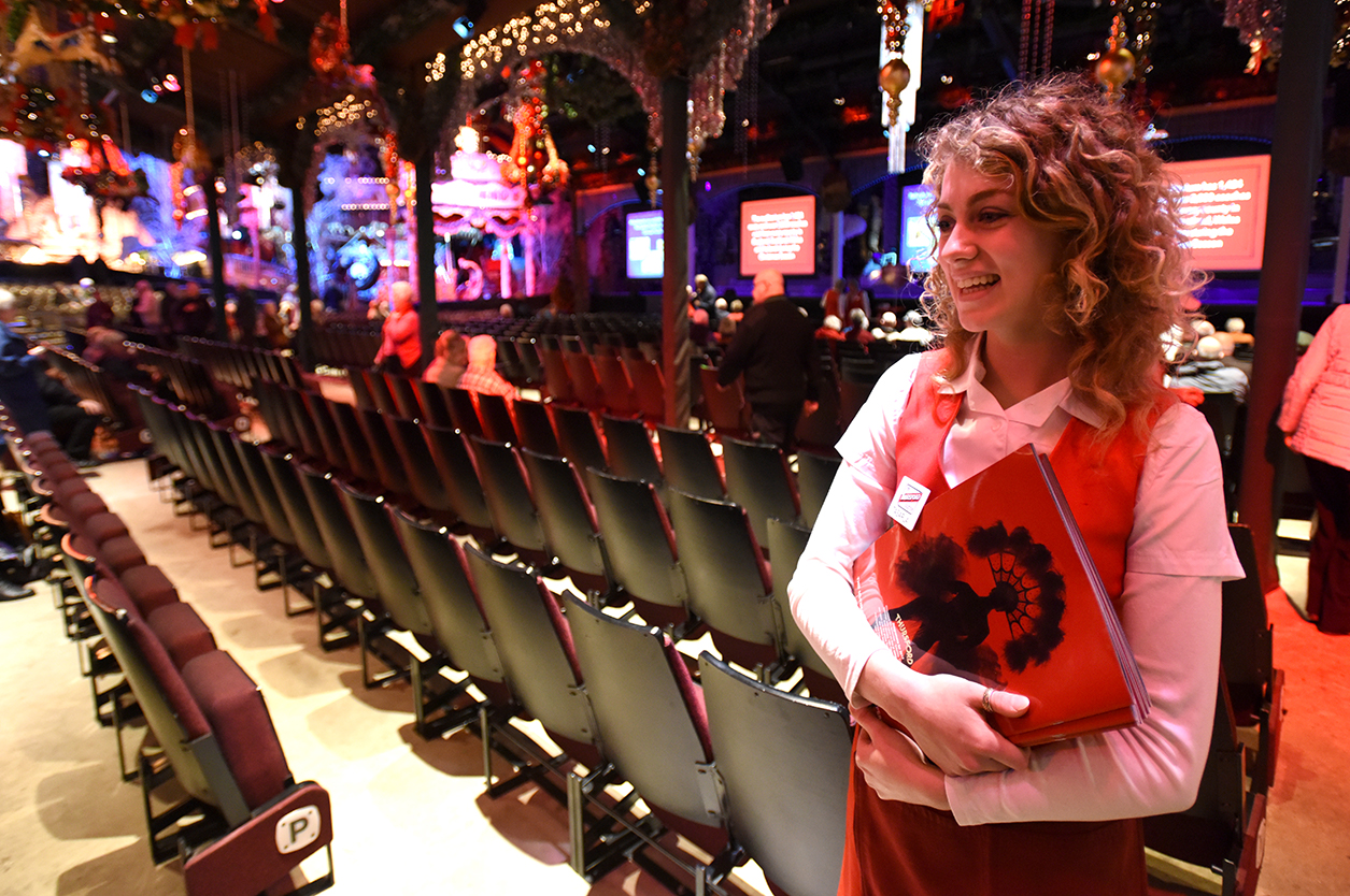 christmas show theatre staff member selling programmes